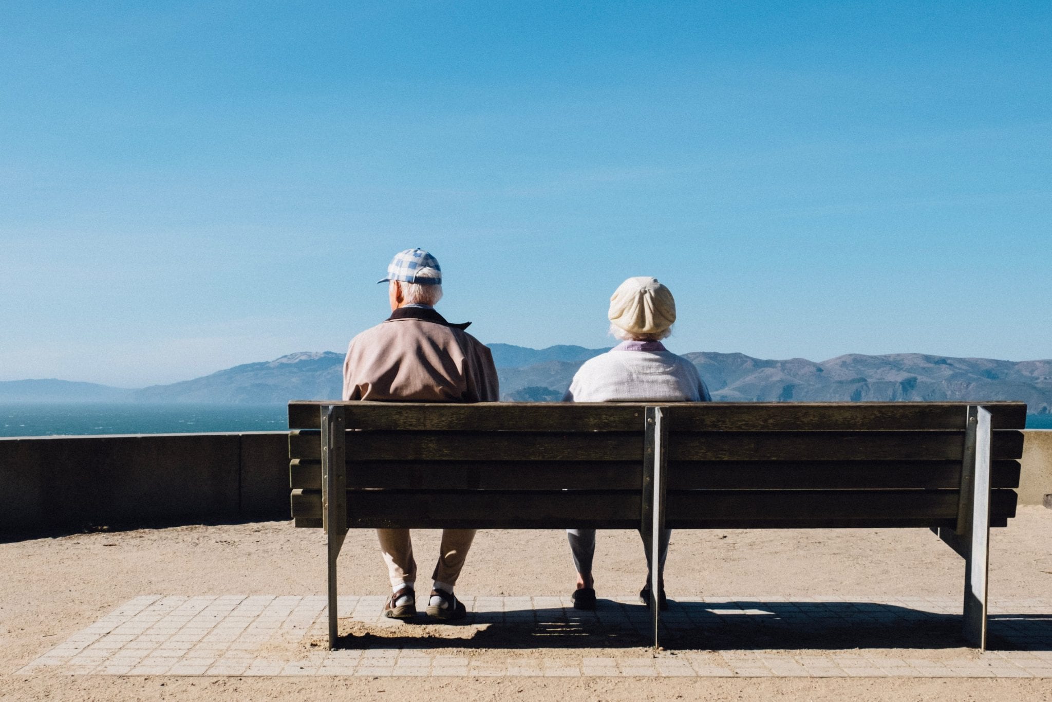 couple on bench older faces hidden