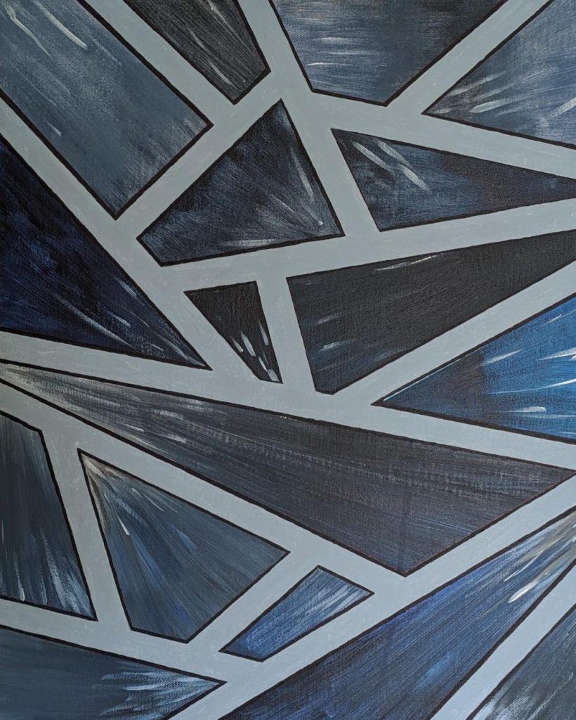 An abstract geometric picture created with grey and blue triangles and quadrilaterals, separated by thick white lines.