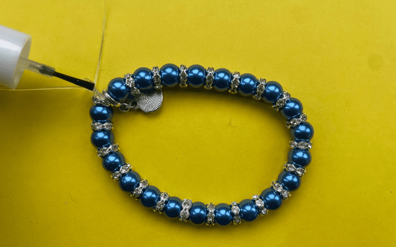 Adding clear nail varnish to elastic.