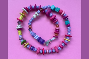 A colourful necklace made out of wooden shapes.