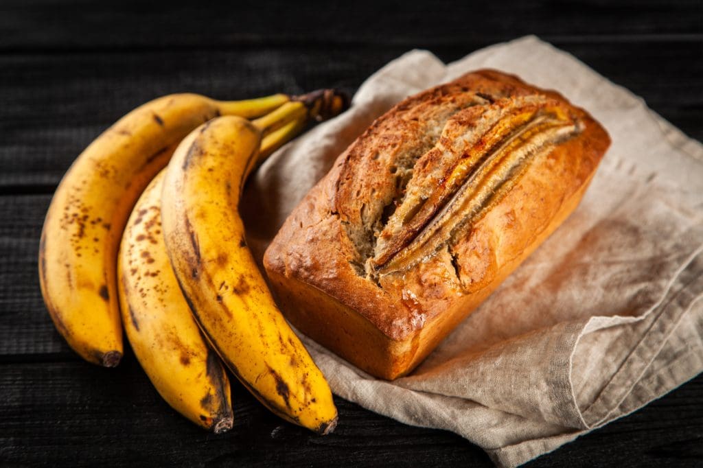 Banana bread and a bunch of bananas.